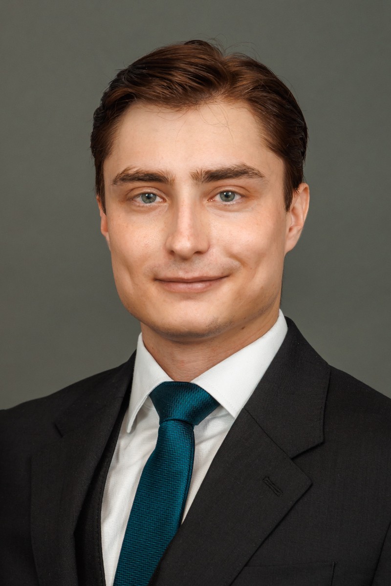 Portrait of Konrad Suchodolski in a dark suit and teal tie